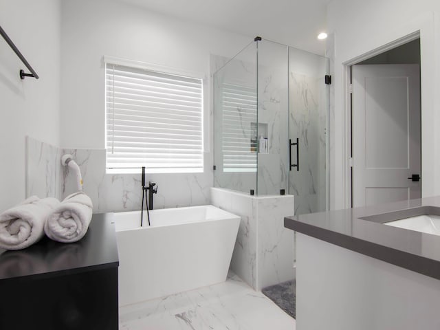 bathroom with vanity and separate shower and tub