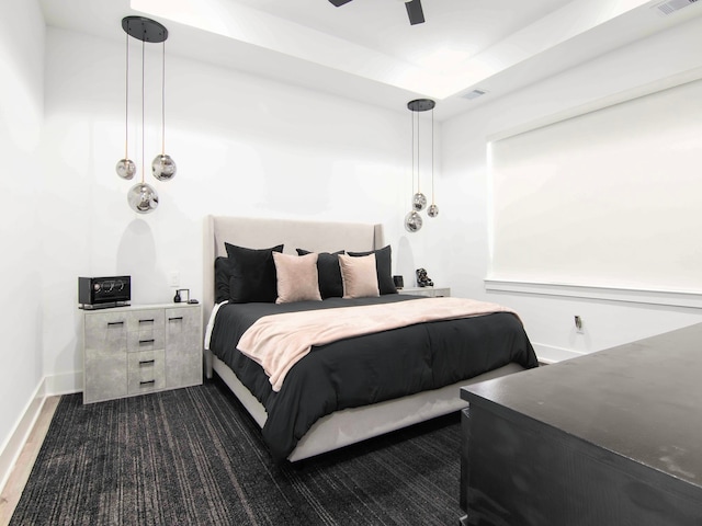 bedroom with ceiling fan and dark hardwood / wood-style flooring