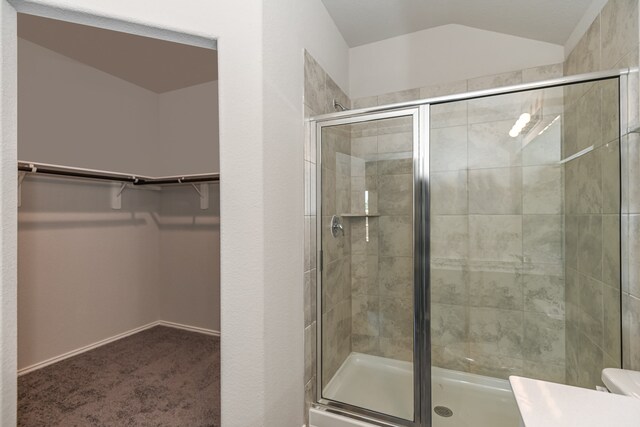 bathroom with toilet and an enclosed shower