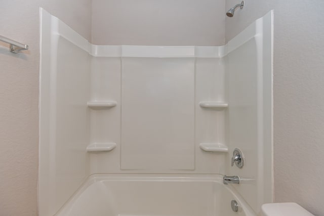 bathroom featuring toilet and tub / shower combination