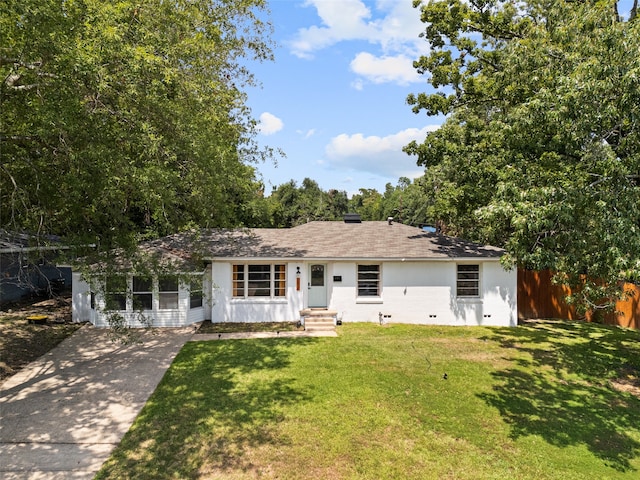 ranch-style home with a front lawn