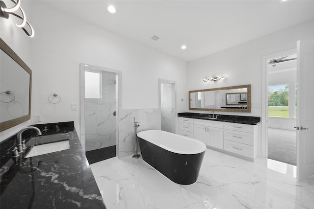 bathroom featuring tile patterned flooring, vanity, and plus walk in shower