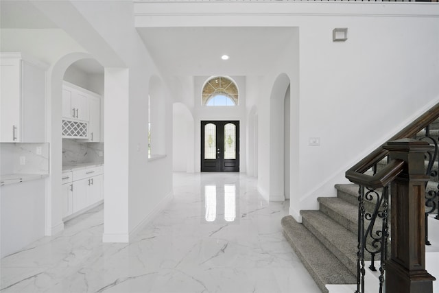 entrance foyer with french doors and light tile patterned flooring