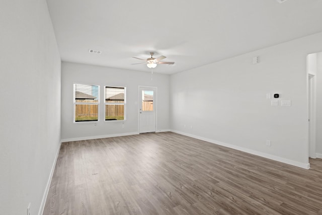 spare room featuring hardwood / wood-style floors and ceiling fan