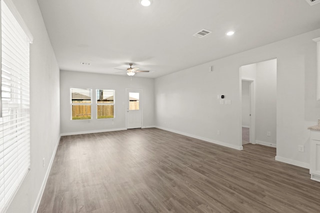 empty room with dark hardwood / wood-style floors and ceiling fan