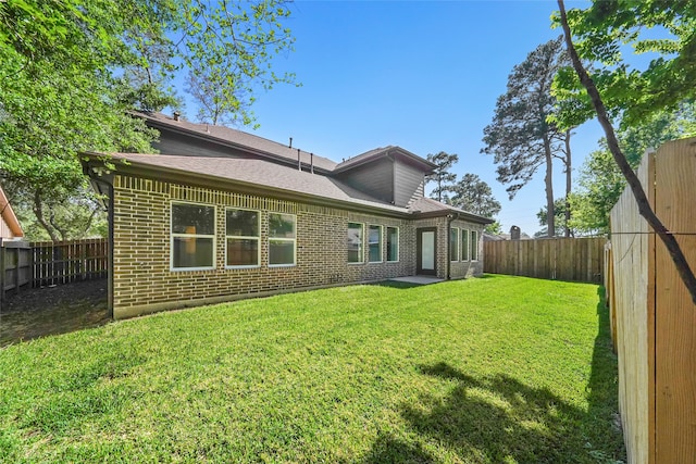 back of house featuring a yard