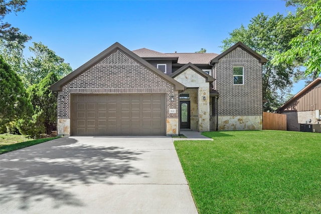 view of front of property featuring a garage and a front yard