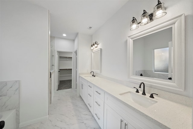 bathroom featuring vanity, a bathing tub, and tile patterned flooring