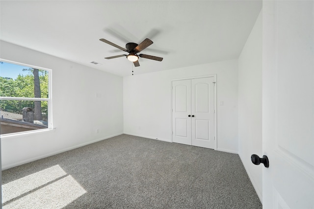 unfurnished bedroom with a closet, ceiling fan, and carpet