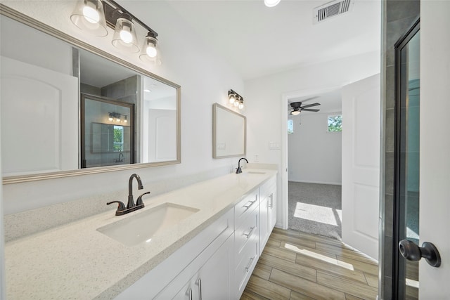 bathroom featuring vanity, ceiling fan, and walk in shower