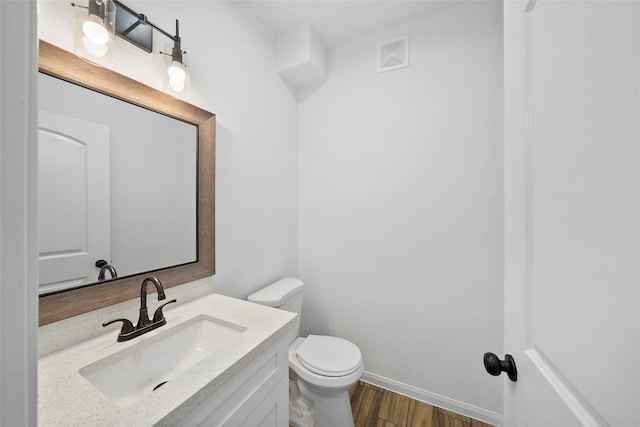 bathroom featuring vanity, toilet, and wood-type flooring