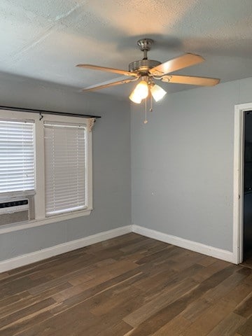 unfurnished room with dark wood-type flooring, cooling unit, and ceiling fan