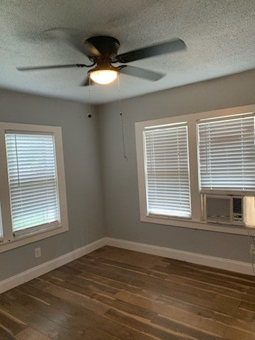 spare room with a textured ceiling, ceiling fan, dark hardwood / wood-style floors, and cooling unit