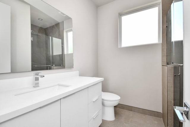 bathroom featuring vanity, toilet, an enclosed shower, and tile patterned flooring