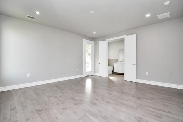 spare room featuring light hardwood / wood-style floors