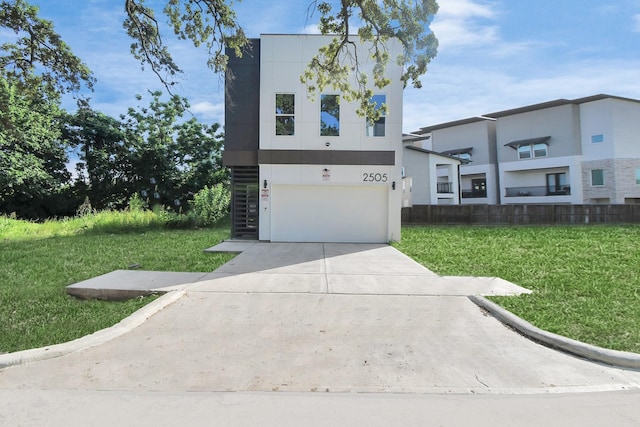 contemporary home featuring a garage and a front yard