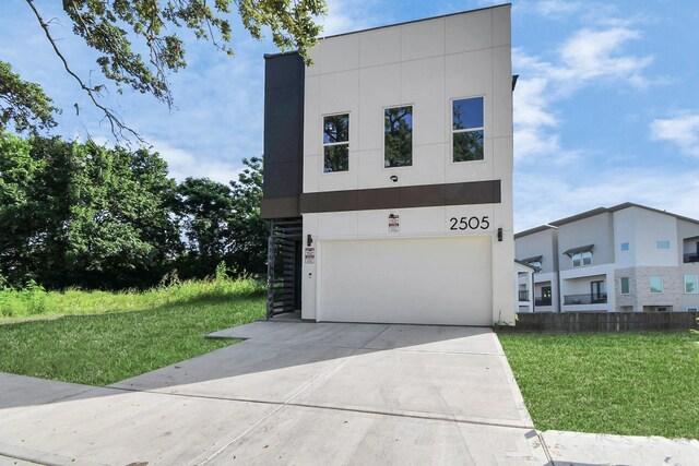 contemporary house with a front lawn and a garage