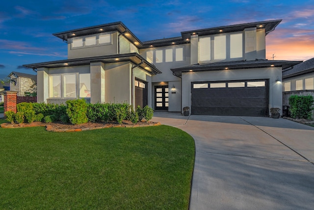 view of front facade with a garage and a lawn