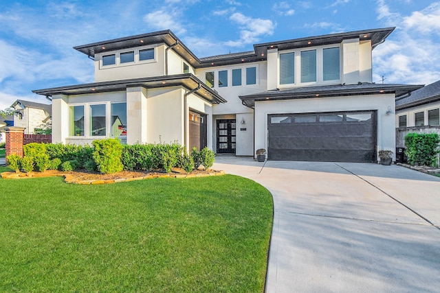 view of front of property featuring a garage and a front lawn