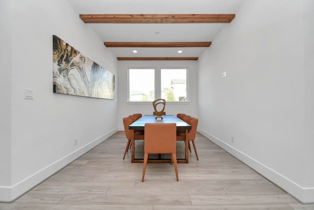 dining area with beam ceiling and light hardwood / wood-style floors