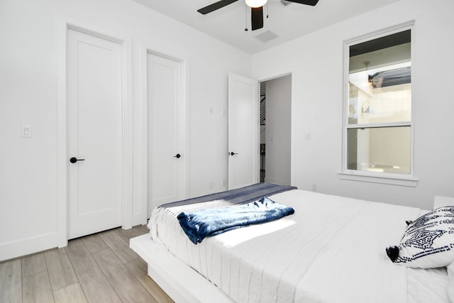 bedroom with ceiling fan and light hardwood / wood-style floors