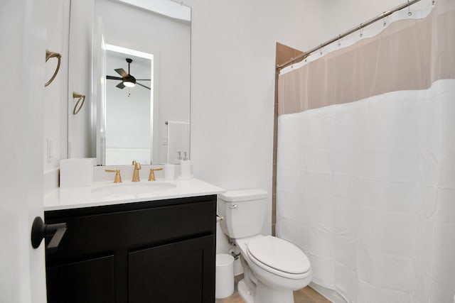 bathroom with vanity, toilet, a shower with curtain, and ceiling fan