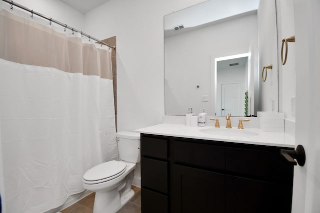 bathroom featuring curtained shower, tile patterned flooring, toilet, and vanity