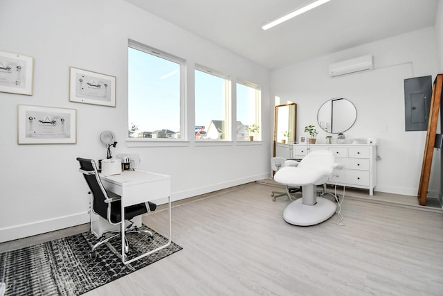 interior space featuring electric panel, wood finished floors, baseboards, and a wall mounted air conditioner