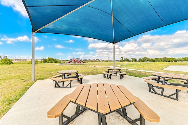 view of home's community featuring a lawn and a playground