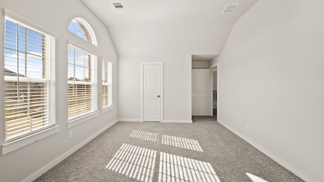 unfurnished bedroom with lofted ceiling and carpet floors