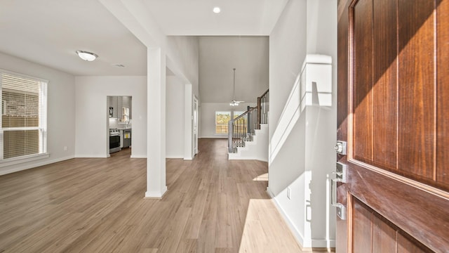 foyer with ceiling fan and light wood-type flooring