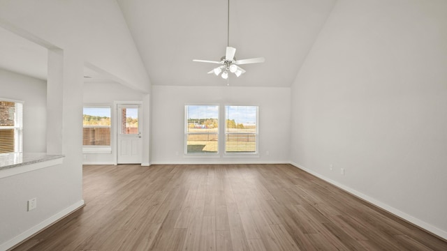 unfurnished living room featuring ceiling fan, high vaulted ceiling, and hardwood / wood-style flooring