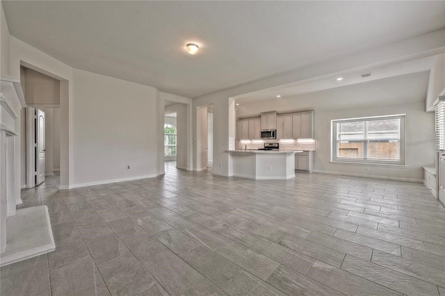 unfurnished living room with a wealth of natural light and light hardwood / wood-style flooring