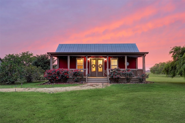 view of front facade with a porch and a yard