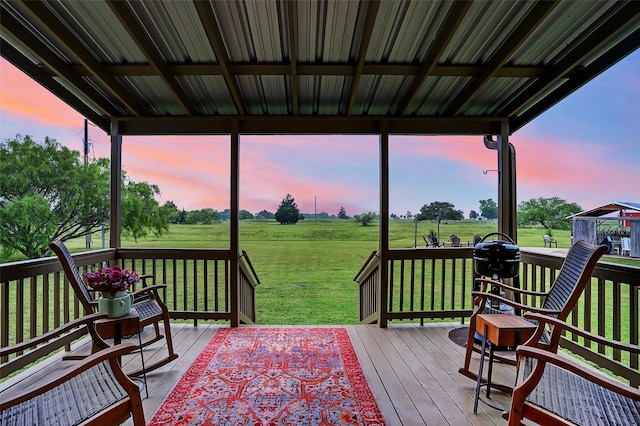 deck at dusk with a lawn