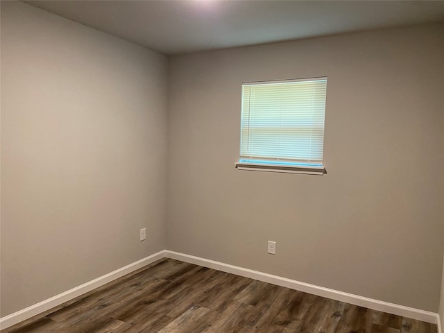 unfurnished room featuring dark hardwood / wood-style flooring