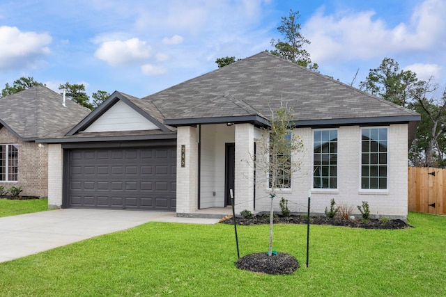 view of front of home with a garage and a front yard