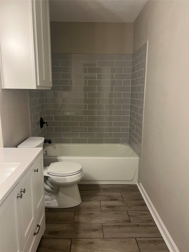 full bathroom featuring vanity, toilet, and tiled shower / bath combo