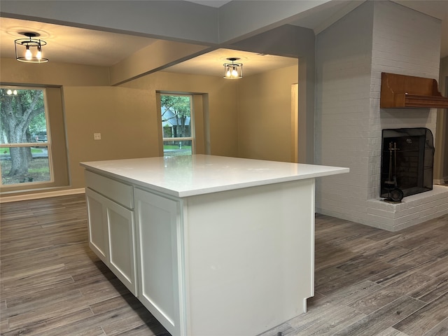 kitchen featuring plenty of natural light, hardwood / wood-style flooring, and white cabinets