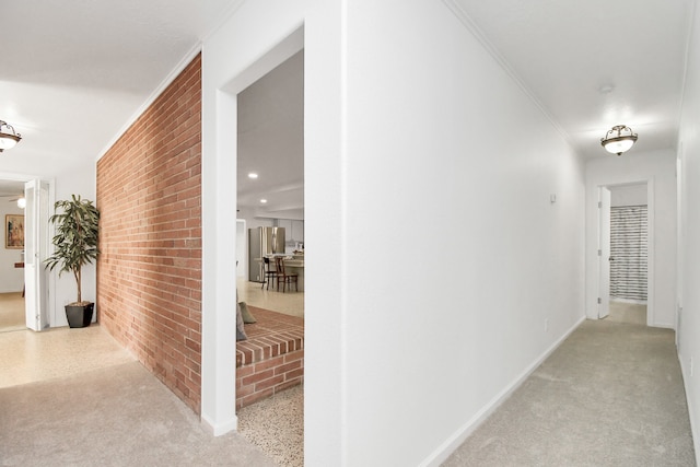 hallway with brick wall and ornamental molding