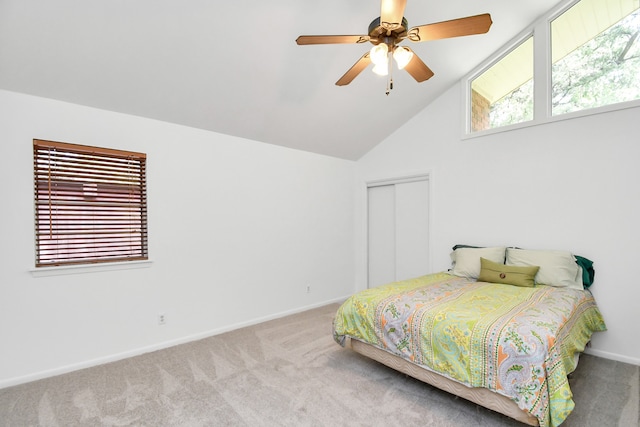 carpeted bedroom with multiple windows, a closet, lofted ceiling, and ceiling fan