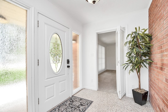 entryway featuring brick wall