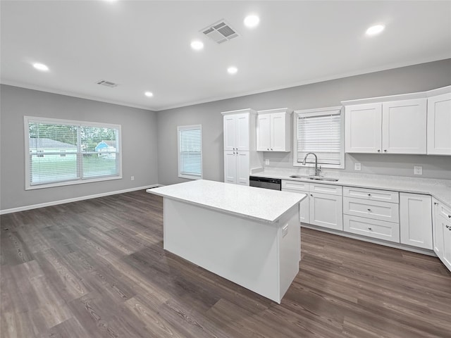 kitchen with white cabinetry, dark hardwood / wood-style flooring, a center island, sink, and stainless steel dishwasher