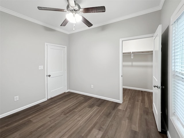 unfurnished bedroom featuring ornamental molding, dark hardwood / wood-style flooring, ceiling fan, and a closet