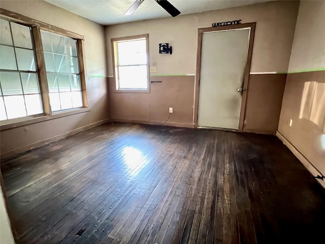 empty room featuring ceiling fan and dark hardwood / wood-style floors