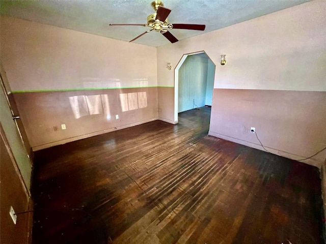 additional living space featuring dark wood-type flooring and ceiling fan