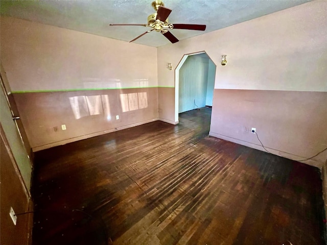 interior space featuring a ceiling fan, wood-type flooring, and baseboards