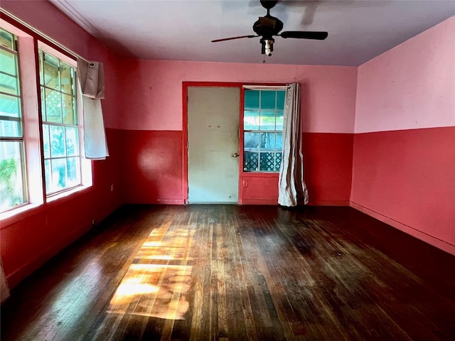 spare room with ceiling fan and dark hardwood / wood-style floors