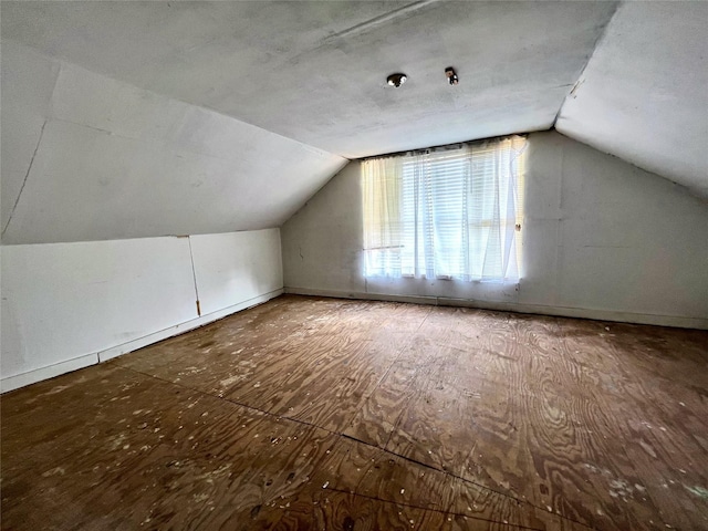 additional living space featuring lofted ceiling