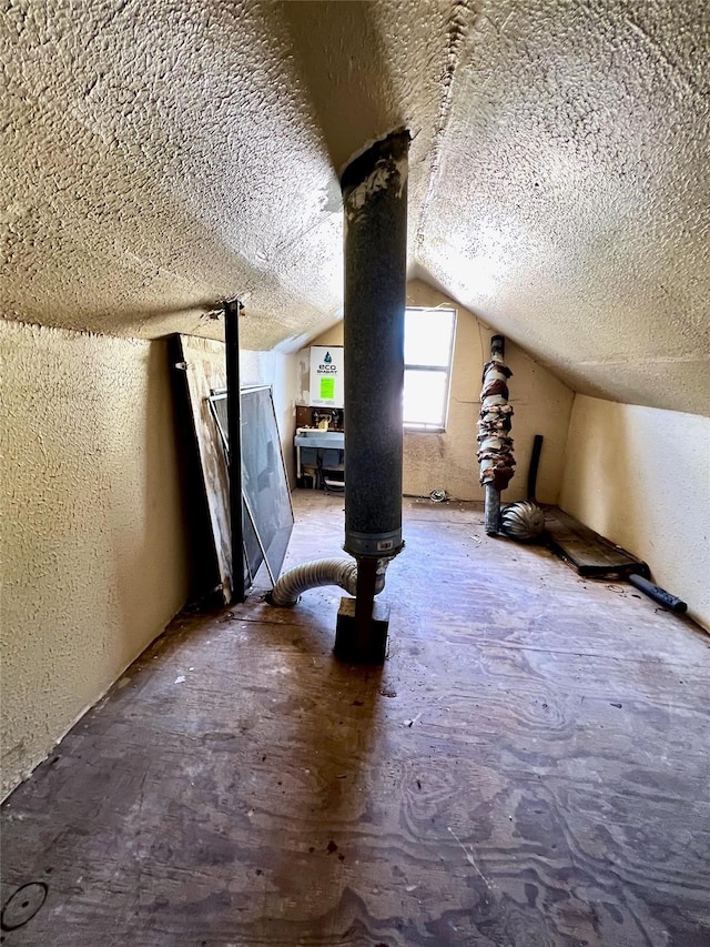 bonus room with vaulted ceiling and a textured ceiling